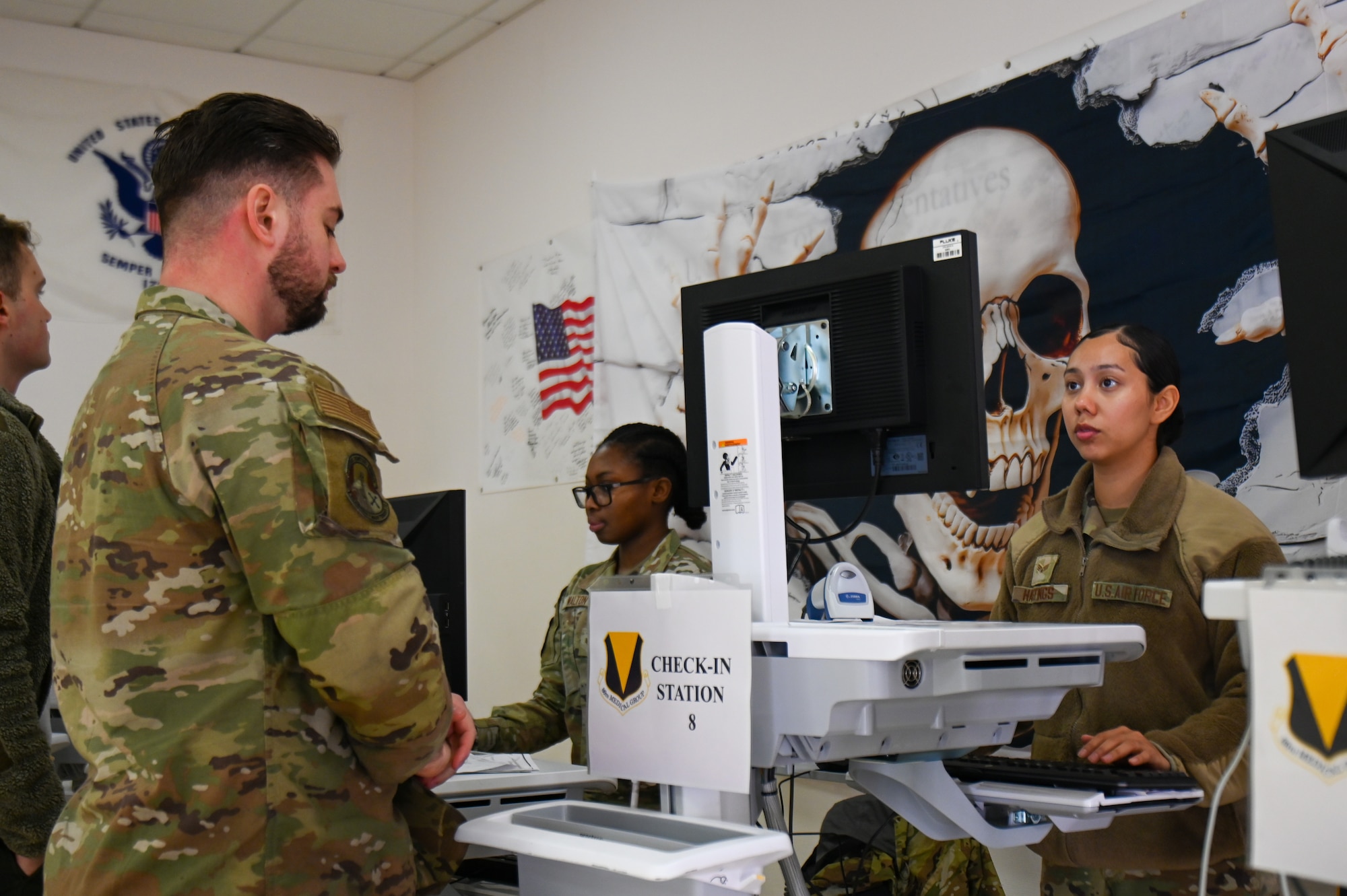 U.S. Air Force Senior Airman Samantha Hastings, 86th Medical Group technician, checks-in a patient during an influenza point of distribution event at Ramstein Air Base, Germany, Oct. 21, 2025. The event reinforced Ramstein’s capability to rapidly execute large-scale medical operations to sustain mission readiness. (U.S. Air Force photo by Airman 1st Class Rebecca Harima)