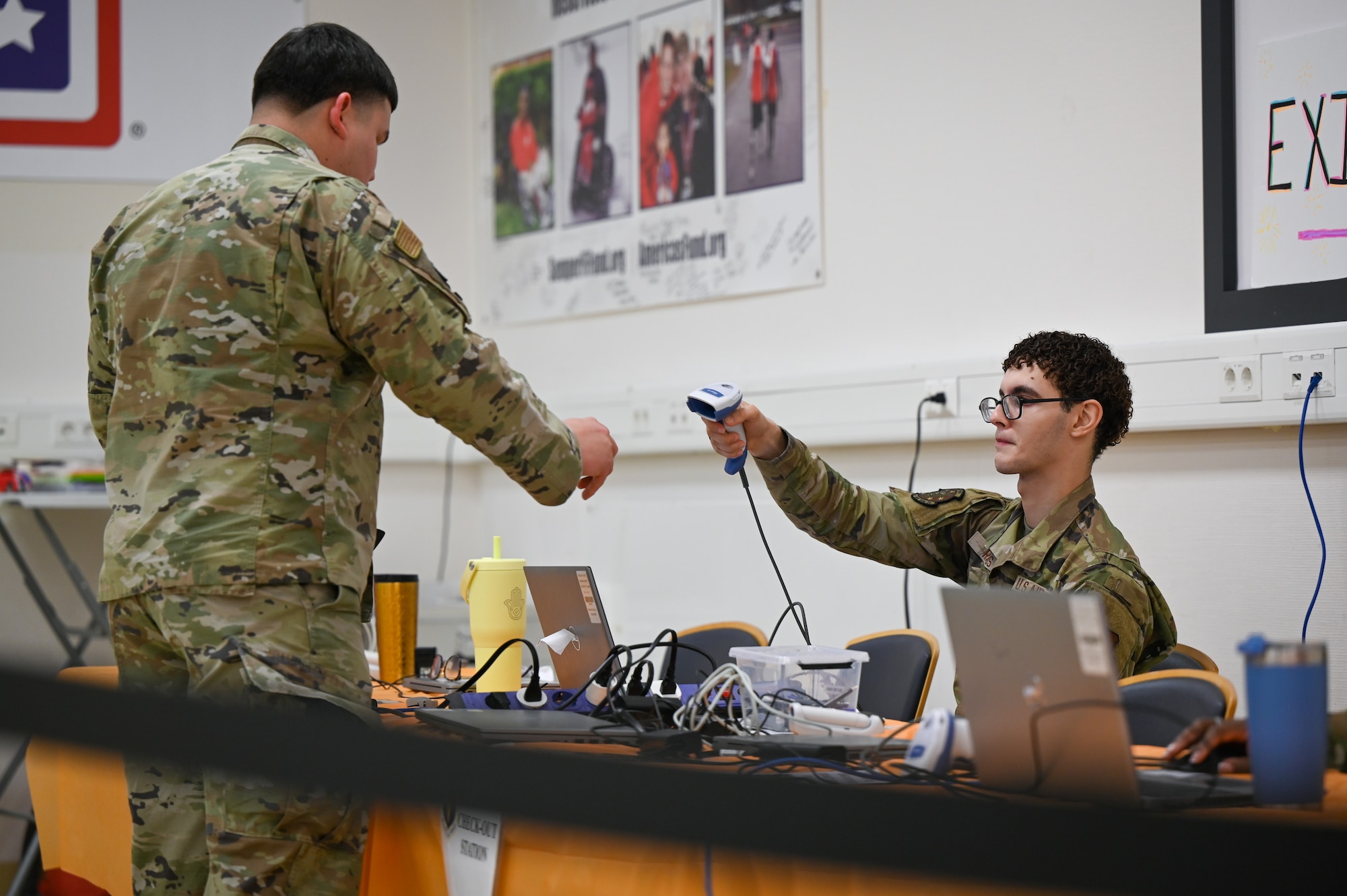 U.S. Air Force Senior Airman Alessandro Ramos, 86th Medical Group administration technician, signs out a patient during an influenza point of distribution event at Ramstein Air Base, Germany, Oct. 21, 2025. The event highlighted the 86th MDG’s commitment to a mission-ready, deployable force. (U.S. Air Force photo by Airman 1st Class Rebecca Harima)