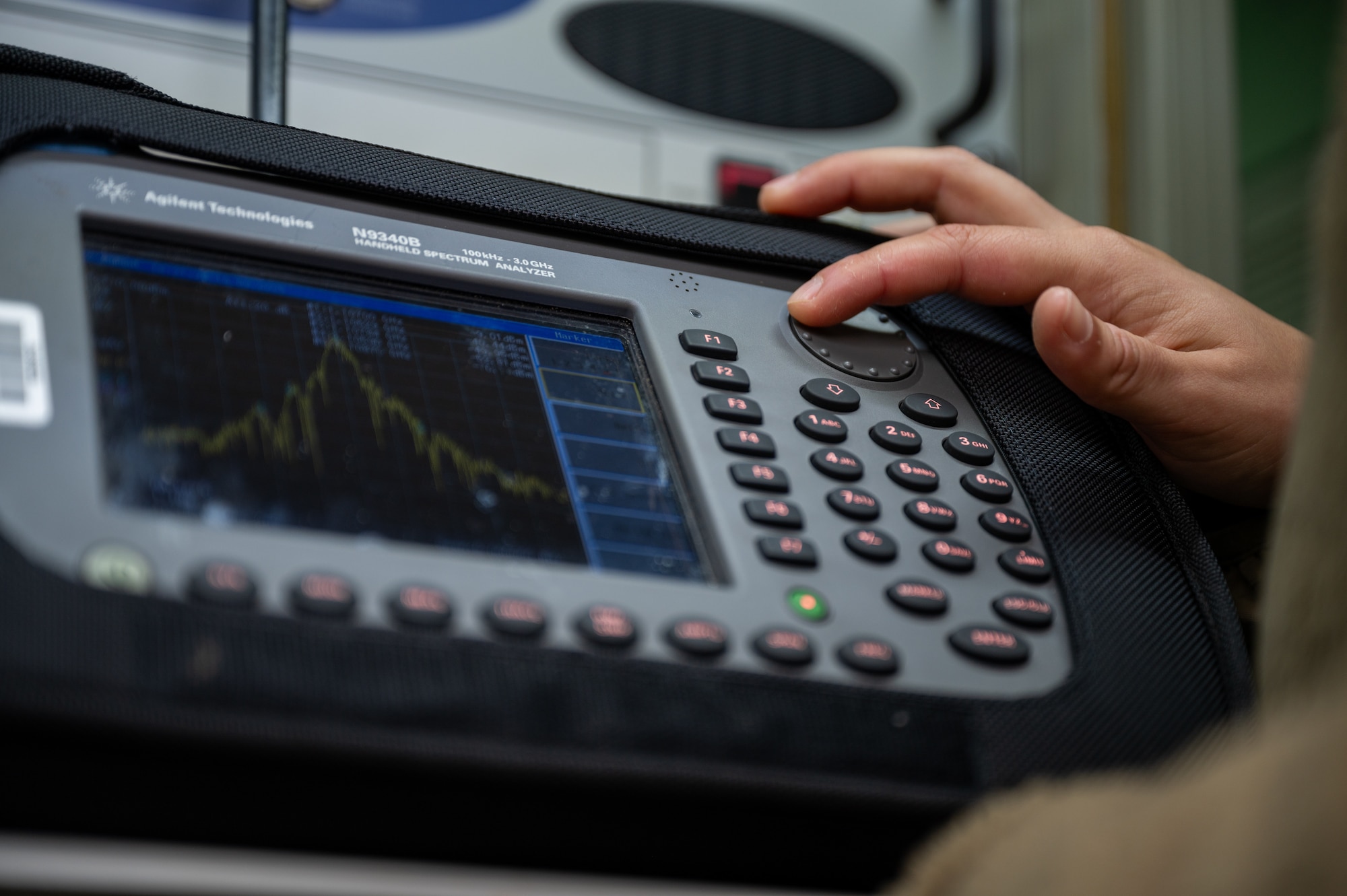U.S. Air Force Staff Sgt. Casey Dorantes, 2nd Combat Weather Systems Squadron radar airfield weather system technician, sets the markers for frequencies up and down the spectrum in a TRN-48 Tactical Air Navigation System to ensure that they meet a specific power ratio at Ramstein Air Base, Germany, Oct. 9, 2025. The mobile TACAN provides reliable guidance for both training and real-world missions. (U.S. Air Force photo by Senior Airman Jared Lovett)