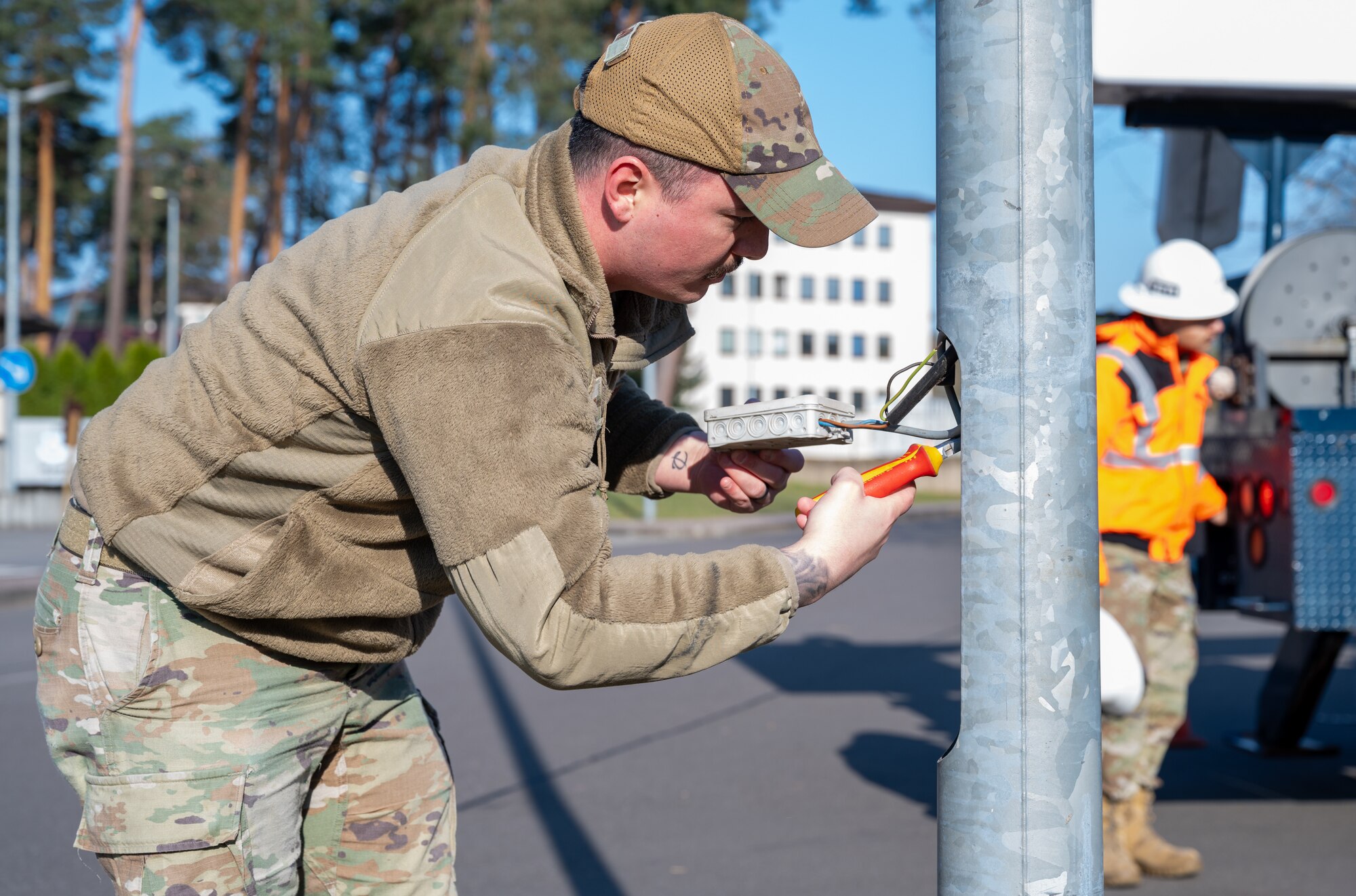 U.S. Air Force Staff Sgt. Brenden Kerwin, 786th Civil Engineer Squadron electrical systems supervisor, de-energizes a light pole at Ramstein Air Base, Germany, April 2, 2025. The 86th Civil Engineer Group supports the largest American military community outside of the United States, maintaining the buildings and infrastructure on multiple military installations within the Kaiserslautern Military Community. The 86th CEG plays a critical role in mission success by laying the foundation to support Airmen and their families. (U.S. Air Force photo by Senior Airman Jared Lovett)