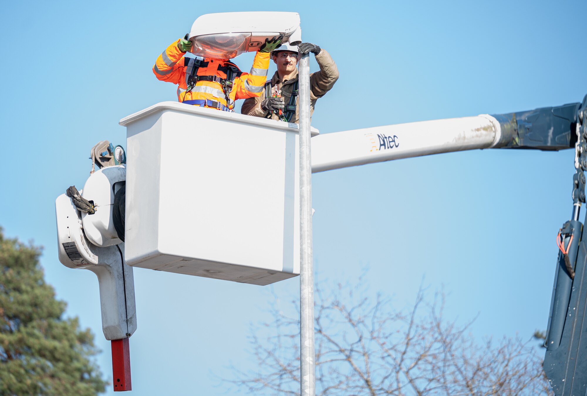 U.S. Air Force Airman 1st Class Ignacio Herrara and Senior Airman Matthew Altenbernd, 786th Civil Engineer Squadron electrical systems journeymen, swap incandescent light fixtures to LED light fixtures at Ramstein Air Base, Germany, April 2, 2025. The 86th Civil Engineer Group supports the largest American military community outside of the United States, maintaining the buildings and infrastructure on multiple military installations within the Kaiserslautern Military Community. The 86th CEG plays a critical role in mission success by laying the foundation to support Airmen and their families. (U.S. Air Force photo by Senior Airman Jared Lovett)