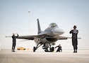 A U.S. Air Force F-16C Fighting Falcon assigned to the 31st Fighter Squadron at Aviano Air Base, Italy, is marshalled by U.S. Air Force F-16 Viper Demonstration Team crew chiefs for the Dubai Airshow at Dubai, United Arab Emirates, Nov. 12, 2025. The VDT performs at airshows across the U.S. and abroad, showcasing the capabilities of the F-16 to a global audience. (U.S. Air Force photo by Staff Sgt. Steven Cardo)