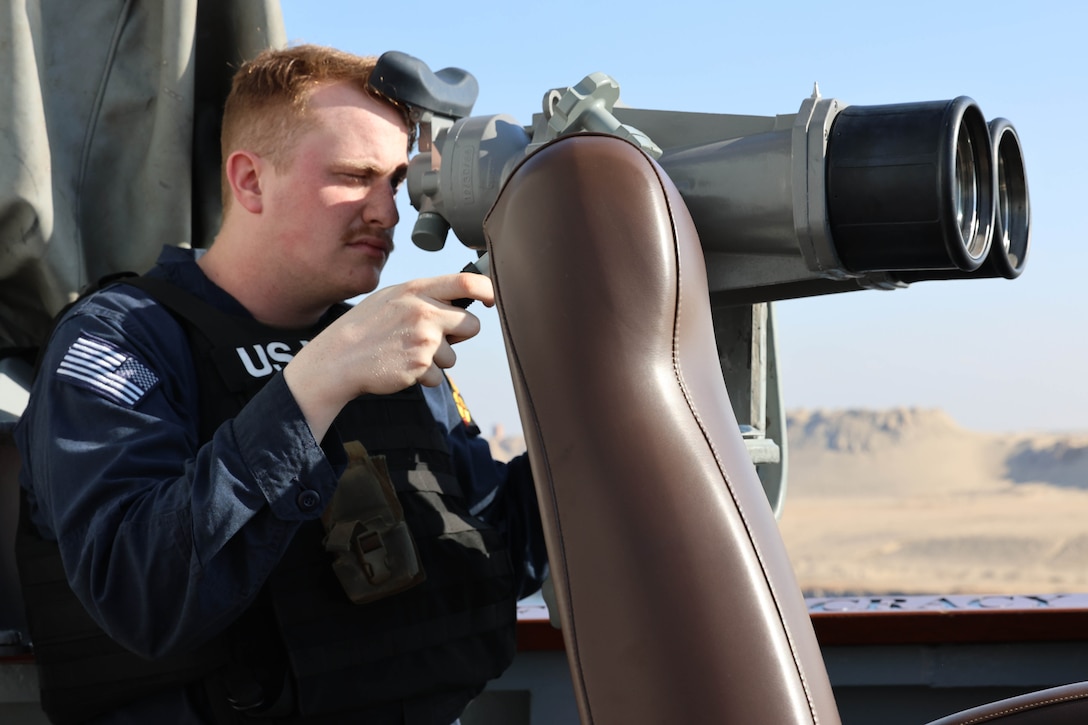 SUEZ CANAL (Nov. 13, 2025) U.S. Navy Sonar Technician (Surface) Seaman Matthew Morris stands small craft action team (SCAT) port lookout watch as the Arleigh Burke-class guided-missile destroyer USS Roosevelt (DDG 80) passes the Friendship Bridge during a Suez Canal transit in the U.S. Central Command (CENTCOM) area of responsibility. Roosevelt is deployed to the U.S. 5th Fleet area of operations to support maritime security and stability in the CENTCOM area of responsibility. (U.S. Navy photo by Mass Communication Specialist 1st Class Indra Beaufort)