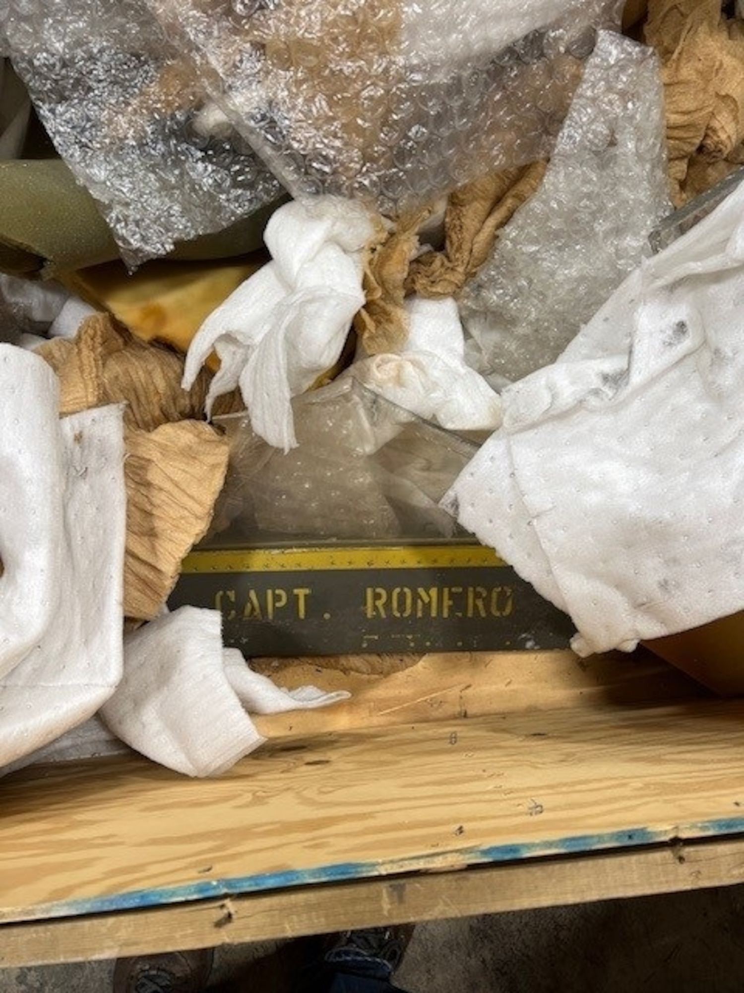 A fractured F-4 Phantom II aircraft canopy is pictured in a warehouse at Arnold Air Force Base, Tenn. The canopy was referred to by Arnold team members involved in its unboxing and subsequent shipment as the “Romero canopy” due to the “Capt. Romero” marking on its frame. It is believed the cockpit cover was either salvaged from an ejection or, more likely, was subjected to bird impact testing at the S-3 Bird Impact Range at Arnold, more famously known as the “Chicken Gun.” Several canopies and a drone engine from the 1980s stored in the warehouse since the late 1980s to early 1990s were shipped this summer to the Air Force Materiel Command History and Heritage Directorate for possible display. (Courtesy photo)
