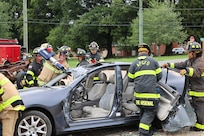 Members of the fire department demonstrate an emergency car rescue.