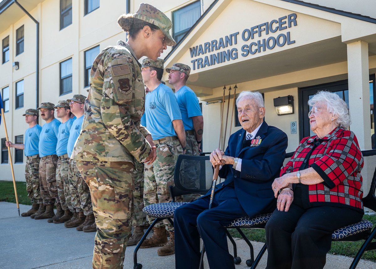 U.S. Air Force Chief Master Sgt. Khamillia A. Washington, Holm Center command chief, speaks with retired Chief Warrant Officer 4 Robert Brow, at Maxwell Air Force Base, Alabama, Nov. 5, 2025.