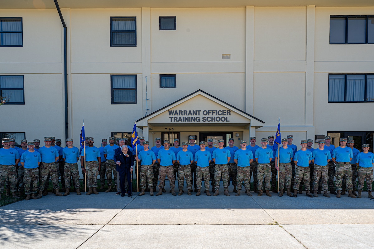 Robert E. Moriarty, left, Headquarters Air Force Deputy Assistant Secretary of the Air Force for Installations and Retired Chief Warrant Officer 4 Robert Brow, second from the left, pose with Warrant Officer Training School candidates at Maxwell Air Force Base, Alabama, Nov. 5, 2025.