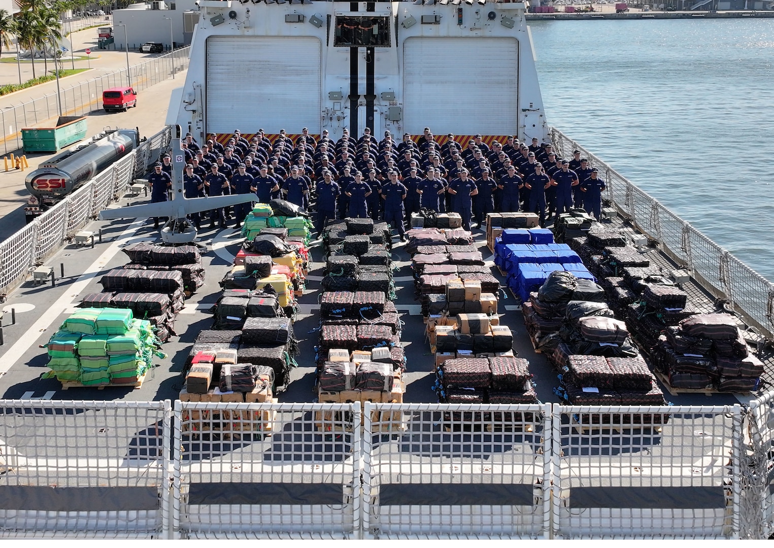 Coast Guard Cutter Stone's crew poses for a group photo on the flight deck of the ship on Nov. 18, 2025, Port Everglades, Florida. Coast Guard Cutter Stone’s crew offloaded approximately 49,010 pounds of illicit narcotics worth more than $362 million. (U.S. Coast Guard photo by Cutter Stone's crew)
