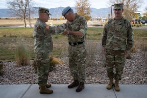 Right, Lt. Gen. Richard Zellmann, deputy commander, U.S. Space Command, joins Lt. Gen. Tom James, former deputy commander, USSPACECOM, as he pins the U.S. Army Basic Space Badge on Maj. Gen. Paul Tedman, commander, U.K. Space Command, during a pinning ceremony at the Aerospace Corporation in Colorado Springs, November 7, 2025. Tedman is the first British Army officer to earn and receive the honor. As the U.K. Space Commander, Tedman plays a key role in the U.S.-U.K. space partnership, facilitating direct communication, collaboration, and alignment of strategic objectives between the two commands. The integration of allies and partners into space operations promotes a common warfighting culture and ensures our steadfast, collective readiness to deter aggression and, if necessary, stand shoulder-to-shoulder and defeat threats.