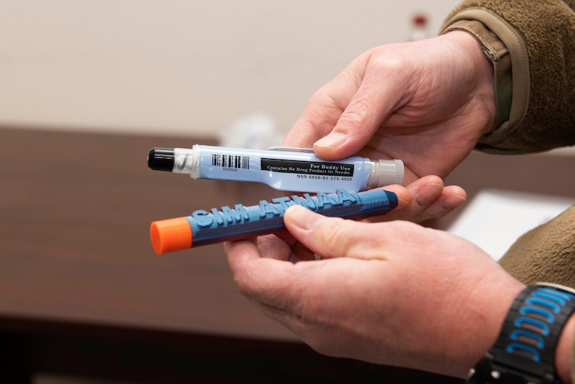 A set of hands holds two small cylindrical barrels.