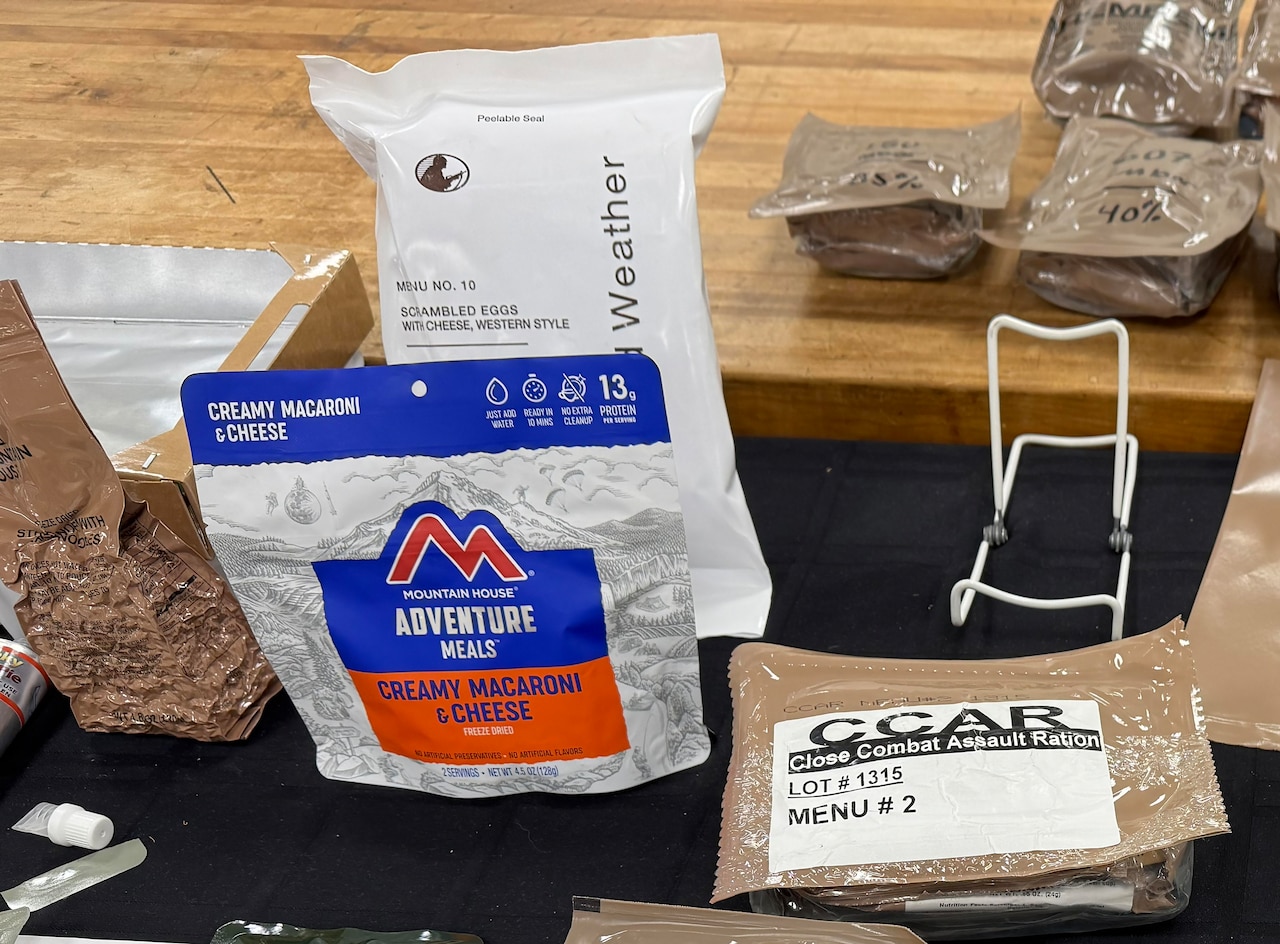Several packages of freeze-dried foods sit on a display table.