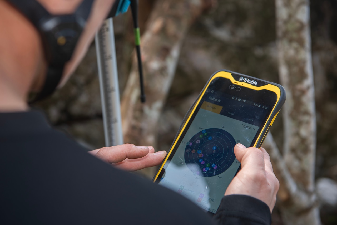A person looks at a screen on a handheld device.