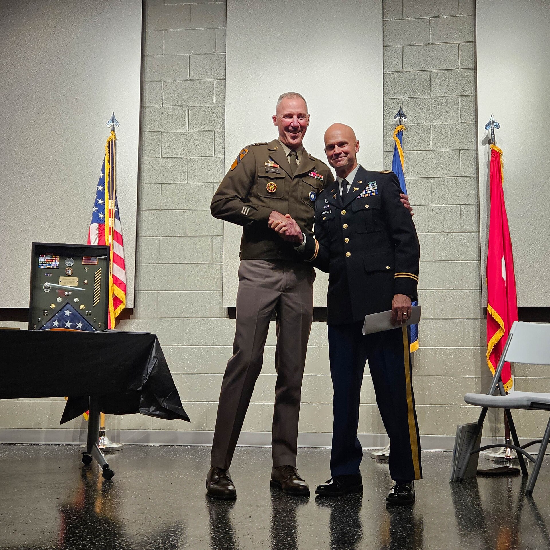 U.S. Army Brig. Gen. Brian Wertzler shakes hands with Col. Christopher Howell after presenting him with the Legion of Merit and Kentucky Distinguished Service Medal. Howell's career spanned 37 years across the Air Force and the Kentucky Army and Air National Guard.
