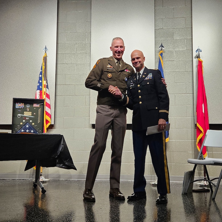 U.S. Army Brig. Gen. Brian Wertzler shakes hands with Col. Christopher Howell after presenting him with the Legion of Merit and Kentucky Distinguished Service Medal. Howell's career spanned 37 years across the Air Force and the Kentucky Army and Air National Guard.