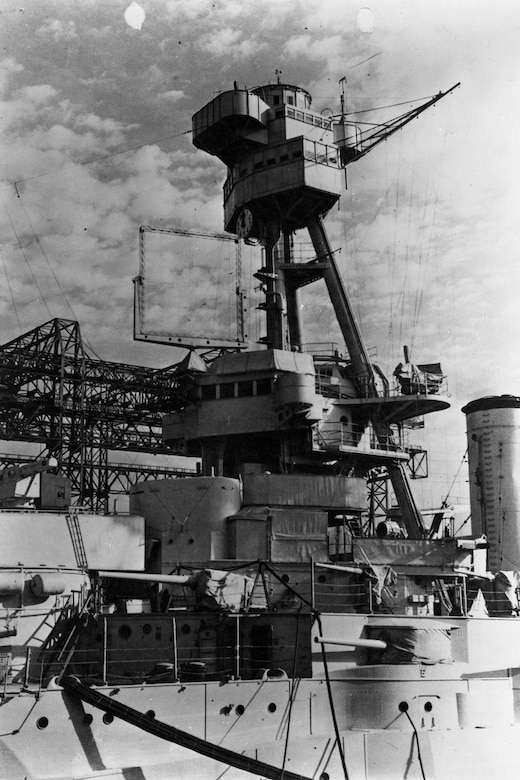 View of a World War II-era battleship with a large, square transmit/receive antenna on it.