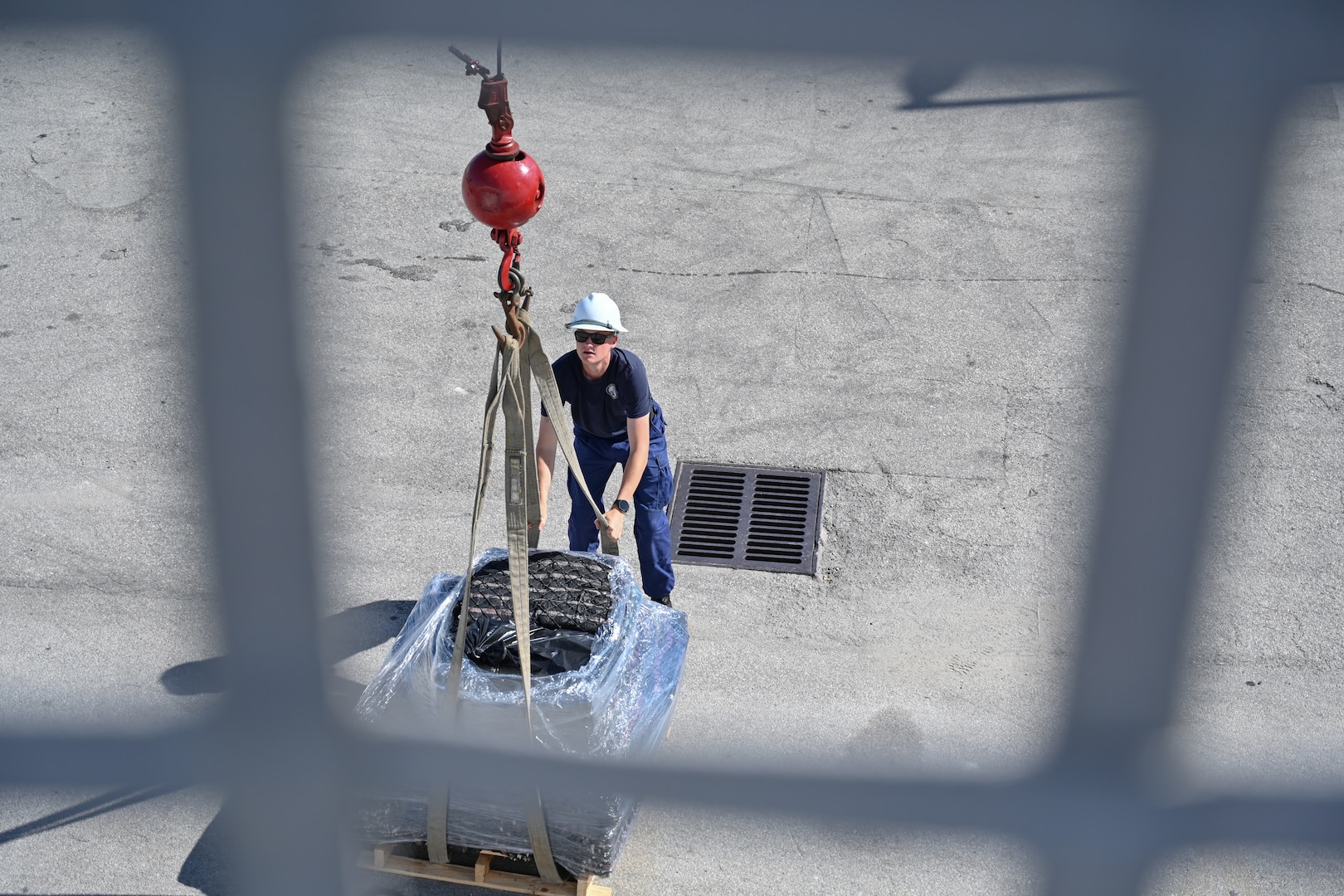 A crew member assigned to Coast Guard Cutter Stone (WMSL 758) offloads a pallet of seized drugs at Port Everglades in Fort Lauderdale, Florida, Nov. 19, 2025. Stone’s crew offloaded approximately 49,010 pounds of illicit narcotics worth more than $362 million. (U.S. Coast Guard photo by Petty Officer 2nd Class Brandon Hillard)