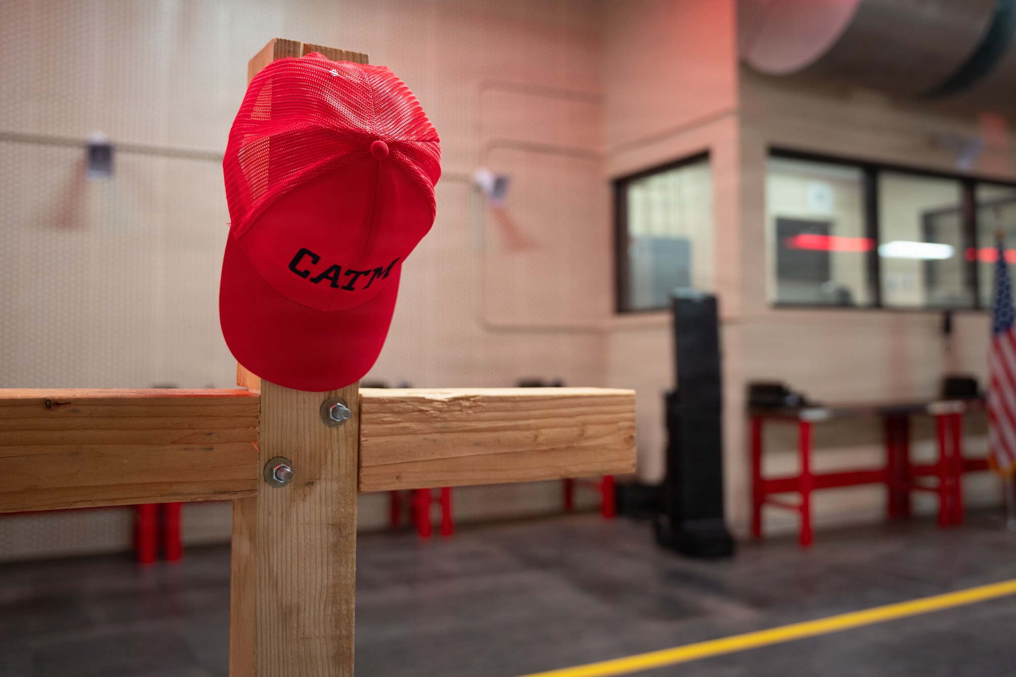 Combat Arms instructors, identified by their red hats, ensure every Defender is proficient and ready to employ weapons at Cannon Air Force Base, New Mexico, Nov. 17, 2025. Instructors operate firing ranges, conduct marksmanship training and maintain a wide array of weapons to strengthen mission readiness. (U.S. Air Force photo by Airman 1st Class Tori Shearn)
