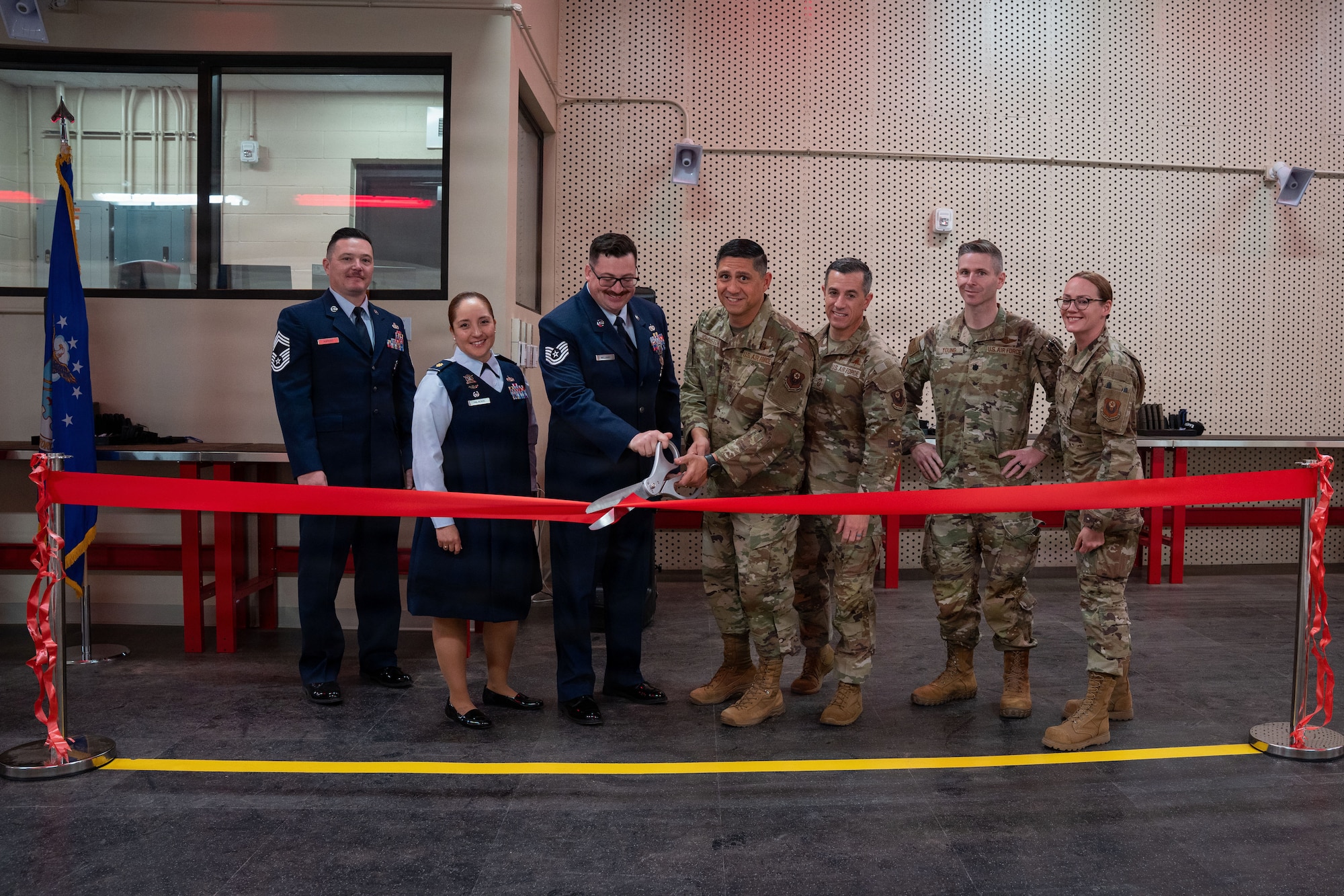 Leadership from across the 27th Special Operations Wing cut a ribbon to celebrate the opening of the new Combat Arms Training and Maintenance facility at Cannon Air Force Base, New Mexico, Nov. 17, 2025. The facility enhances Defender readiness by expanding training, maintenance and weapons proficiency capabilities. (U.S. Air Force photo by Airman 1st Class Tori Shearn)