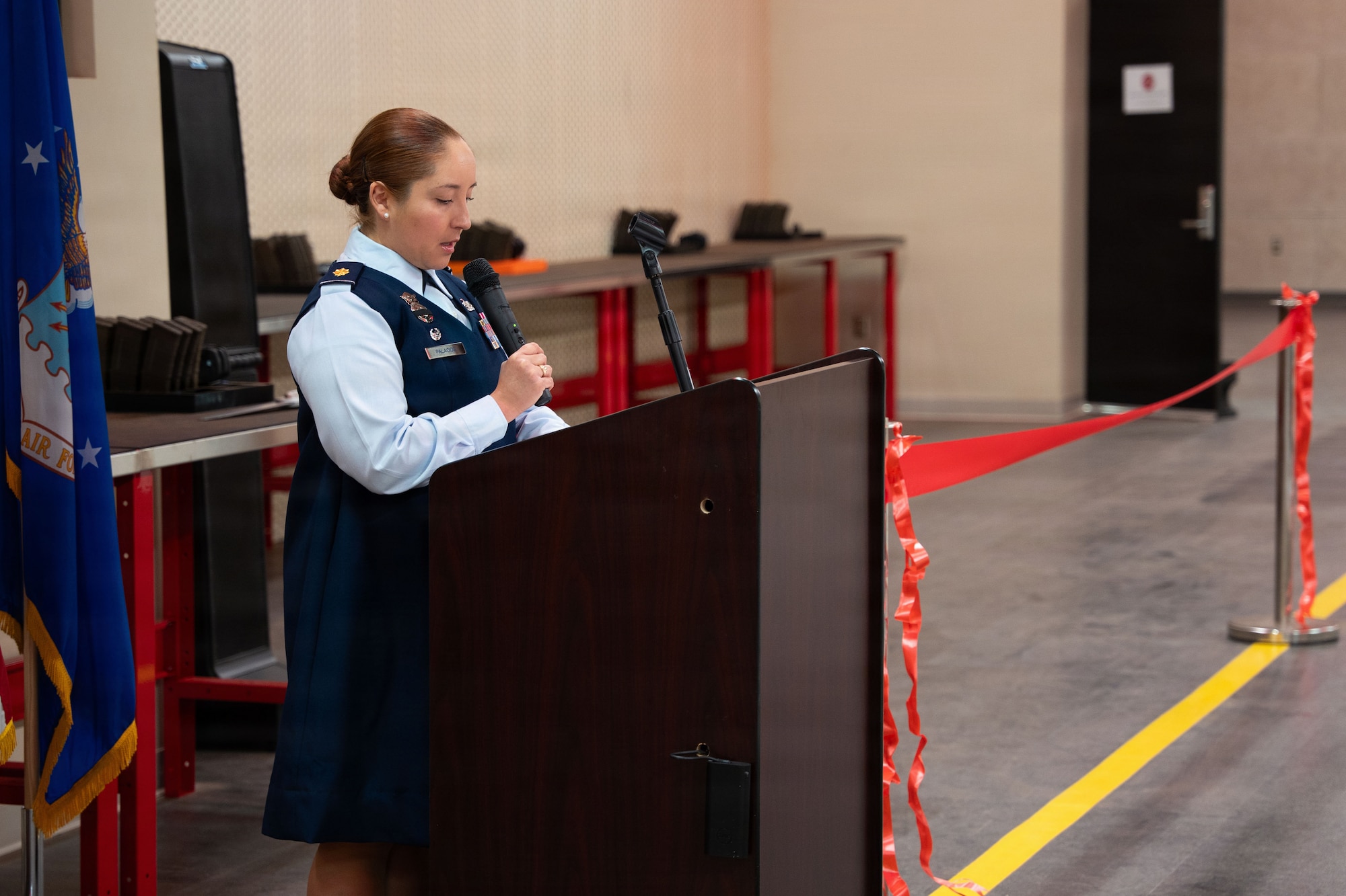 U.S. Air Force Maj. Brigitte Palacios, 27th Special Operations Security Forces Squadron commander delivers remarks during the Combat Arms Training and Maintenance ribbon-cutting ceremony at Cannon Air Force Base, New Mexico, Nov. 17, 2025. Larger classrooms and modern connectivity support updated instructional methods, multiple learning styles and allows CATM to increase qualification throughput from about 4,200 a year to roughly 6,000. (U.S. Air Force photo by Airman 1st Class Tori Shearn)