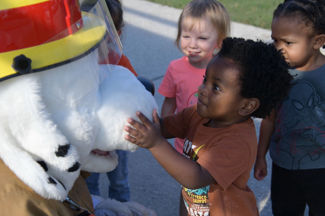Children visit with Sparky the Fire Dog.