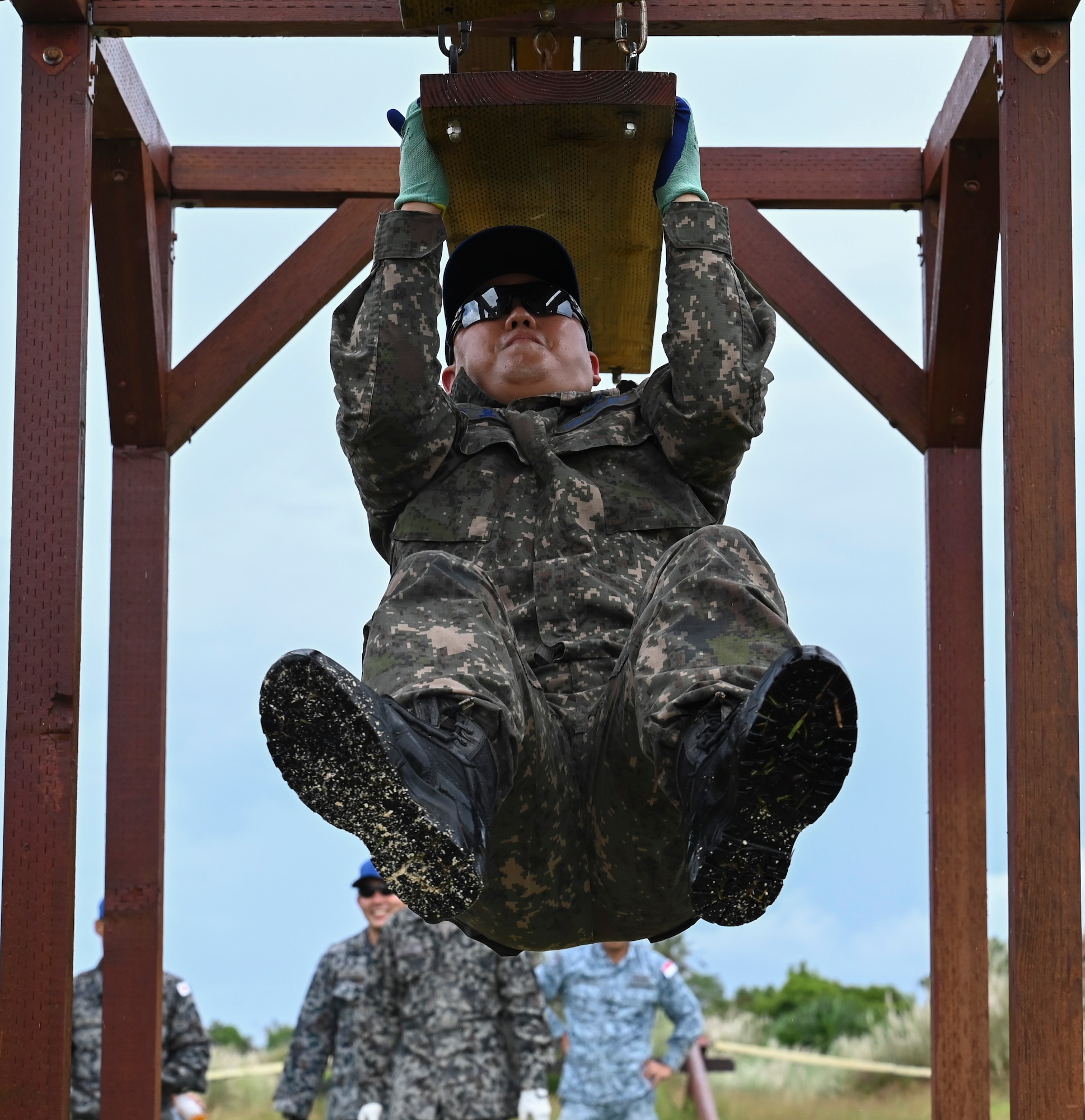 A foreign airman with sunglasses completes part of the obstacle course during Silver Flag.