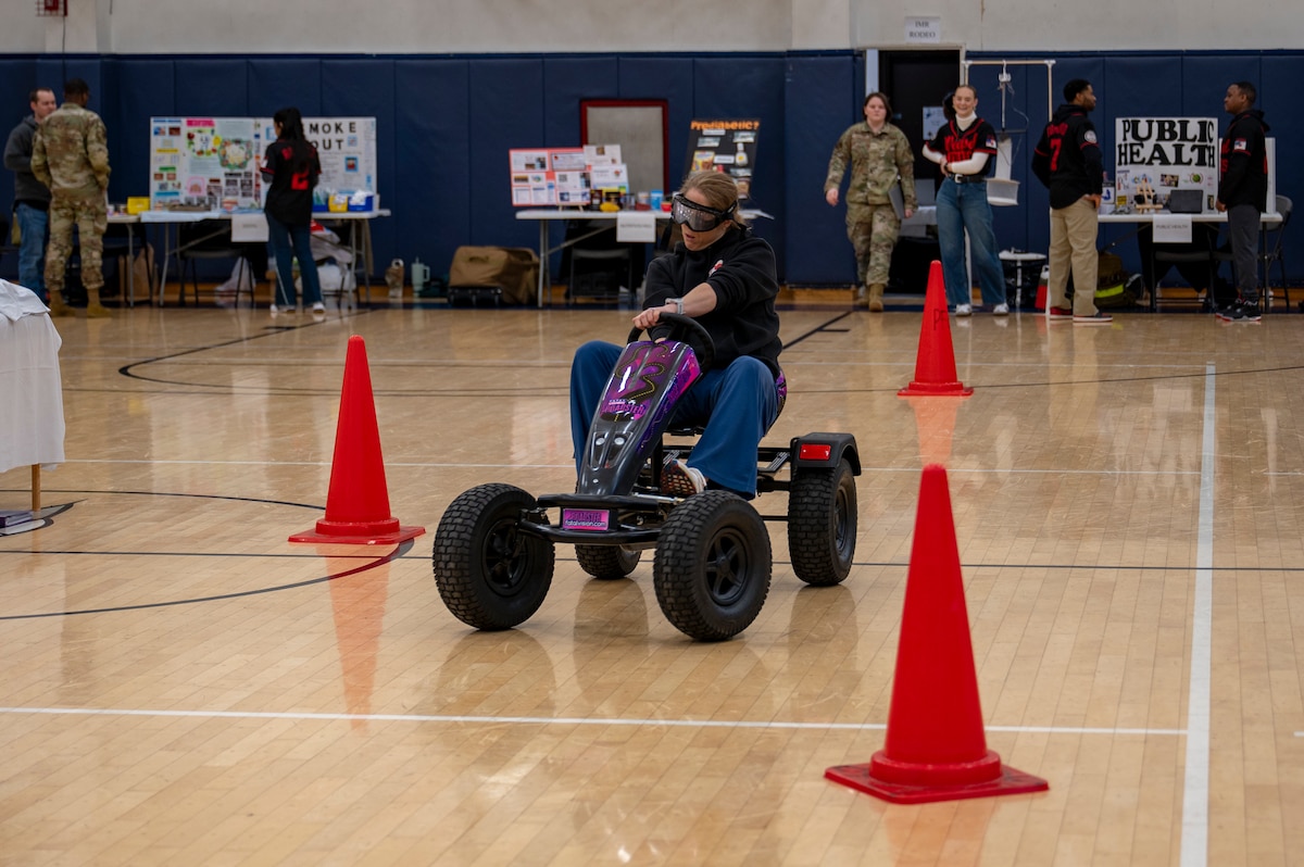 A participant uses a drunk driving simulator during the 2025 Health & Wellness Expo at Misawa Air Base, Japan, Nov. 14, 2025. By promoting awareness and prevention, the event helps ensure Airmen remain safe, resilient and prepared to execute the mission. (U.S. Air Force photo by Senior Airman Brittany Russell)