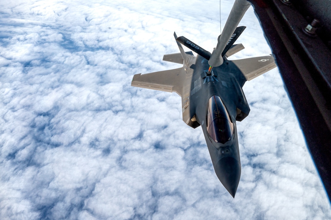A U.S. Air Force F-35A Lightning II assigned to the 4th Expeditionary Fighter Squadron, deployed to Kadena Air Base, conducts aerial refueling with a KC-135 Stratotanker assigned to the 909th Air Refueling Squadron during a local exercise over the Pacific Ocean, Nov. 17, 2025.