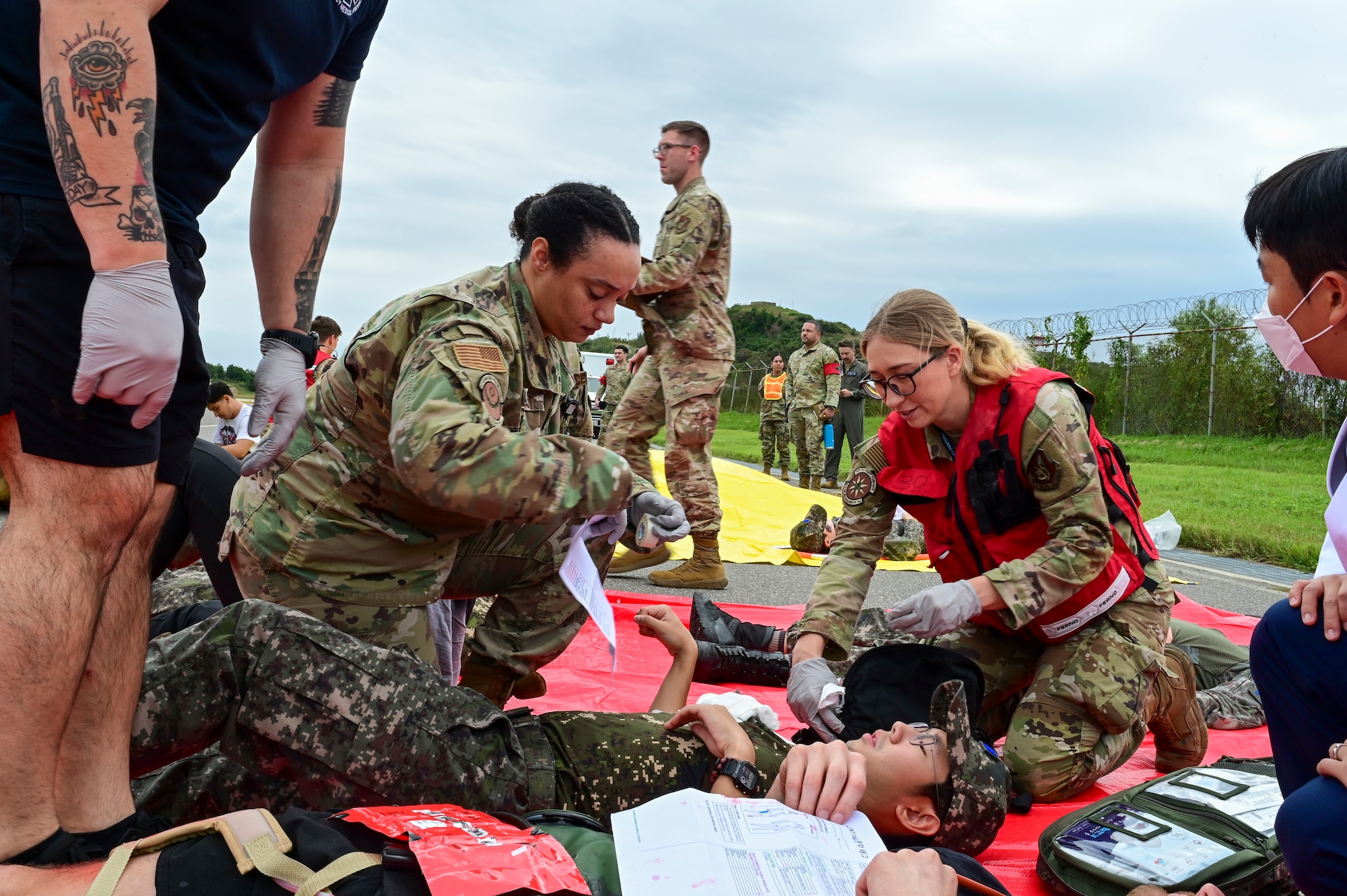 A group helps a patient on the ground.