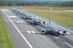 U.S. Air Force KC-46A aircraft assigned to the 157th Air Refueling Wing, New Hampshire National Guard, perform an elephant walk formation on the runway at Pease Air National Guard Base, Sept. 8, 2021. After taxiing, the aircraft were parked on the ramp in preparation for the Thunder Over New Hampshire Air Show. (U.S. Air National Guard Photo by Senior Master Sgt. Timm Huffman)