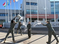 U.S. Air Force student pilots celebrate after completing a T-346A Master Jet Trainer sortie during the undergraduate flying training program Small Group Tryout at the International Flight Training School, Decimomannu Air Base, Italy.
