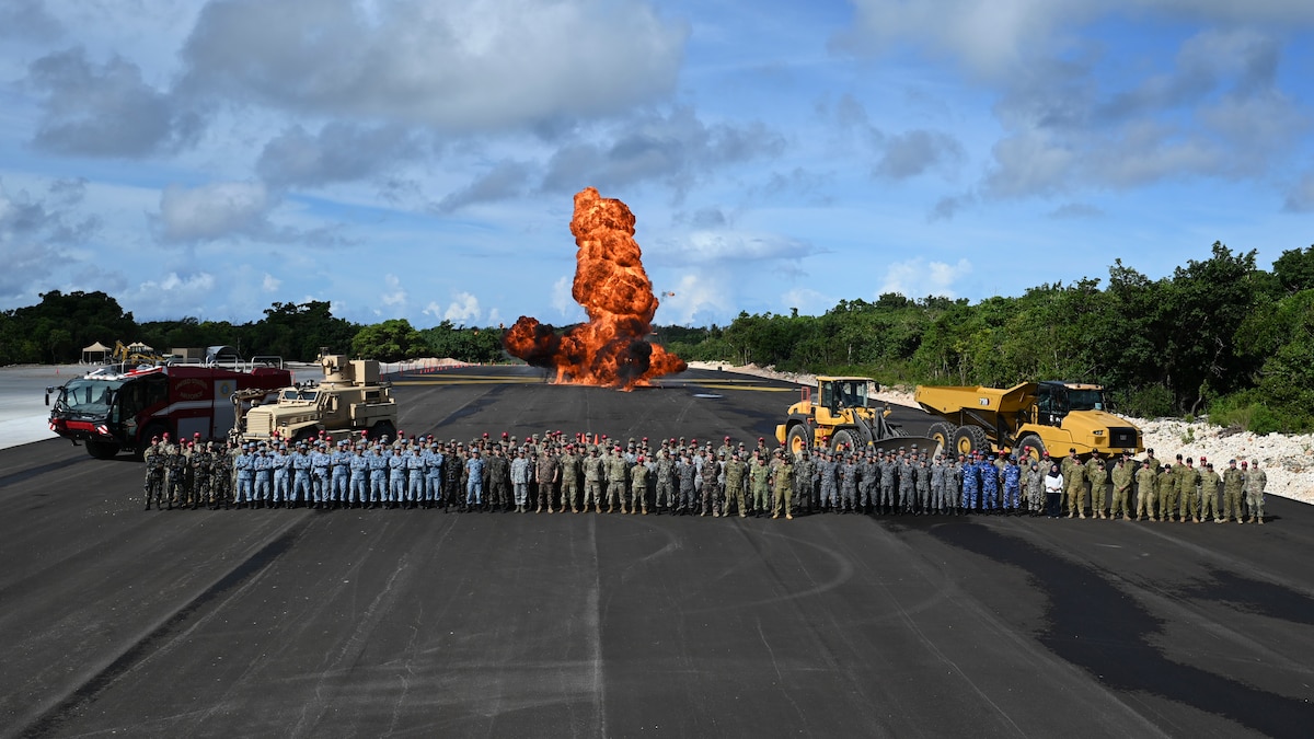 PERC participants pose for photo with an explosion happening in the background.