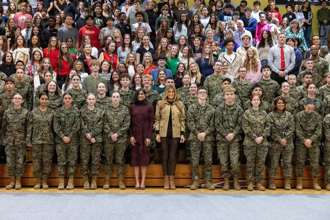 First lady of the United States, Mrs. Melania Trump, and second lady, Mrs. Usha Vance, pose for a photo with students at Lejeune High School on Marine Corps Base Camp Lejeune, North Carolina, Nov. 19, 2025. Trump and Vance made their first visit to a military installation under the second Trump Administration to show appreciation for military families and those who serve this holiday season. During their visit they spent time with students creating holiday crafts and building care packages for deployed service members. The visit culminated with the two women addressing nearly 1,500 service members and their families at Marine Corps Air Station New River. (U.S. Marine Corps photo by Lance Cpl. Erica Padgett)