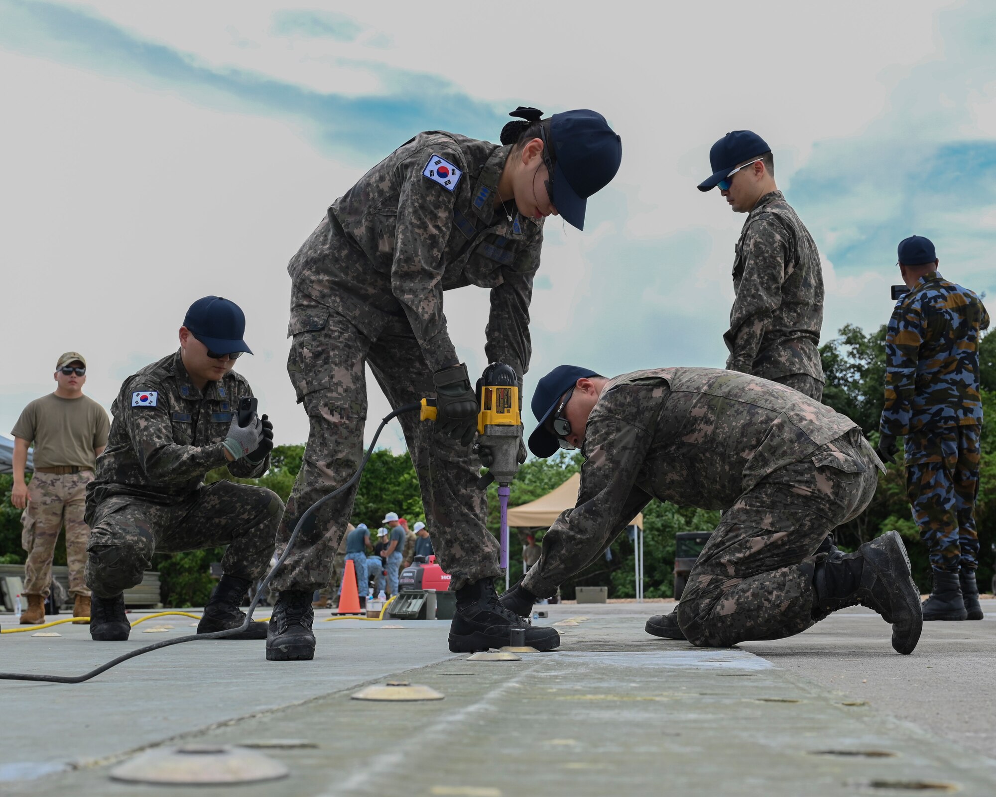 Republic of Korea Air Force airmen use the tools provided to finish their tasks.