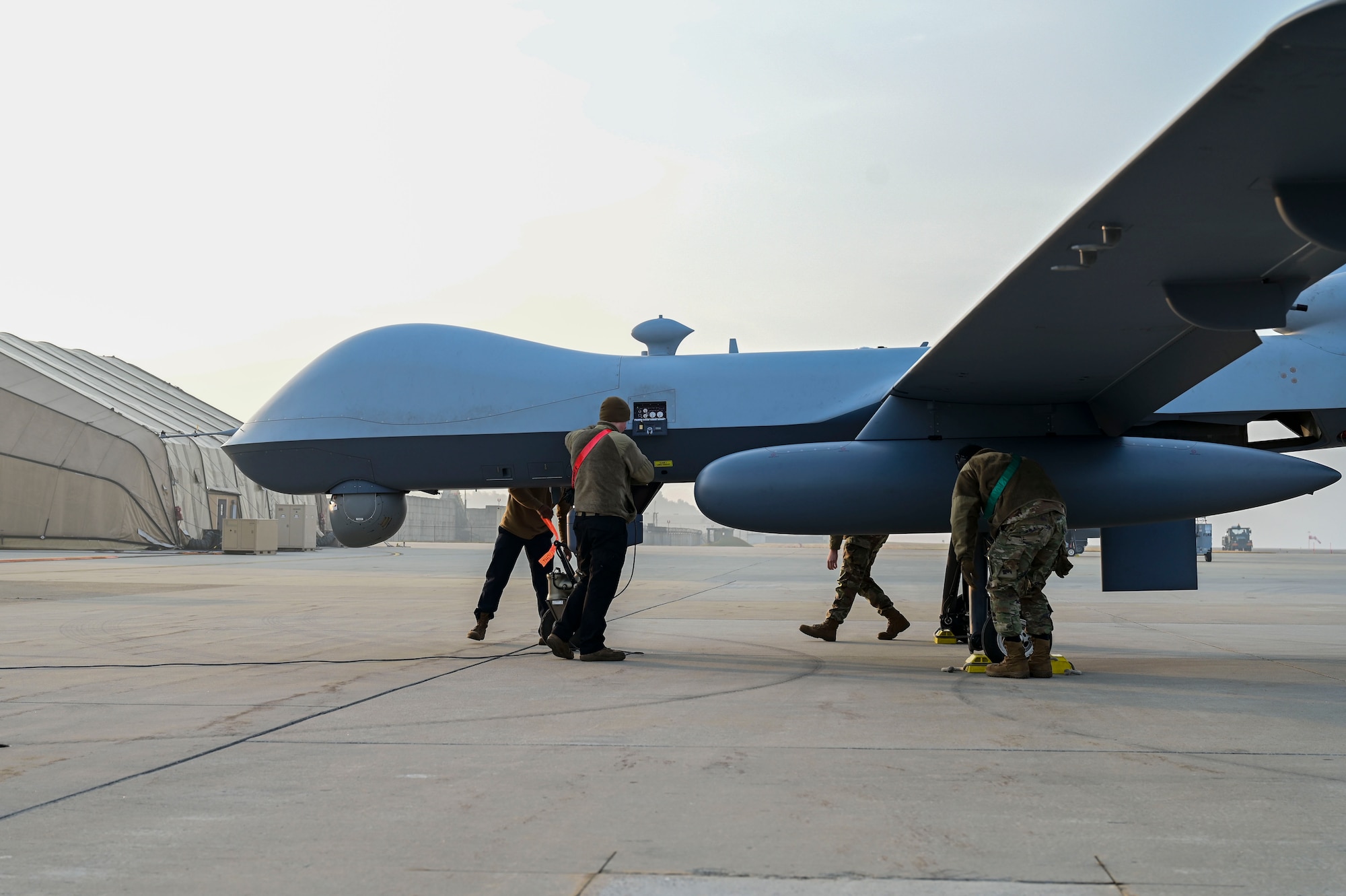 Men surround a drone.