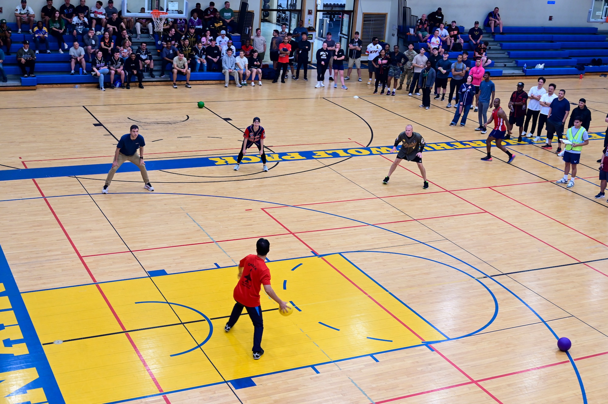 A group stands on a court.