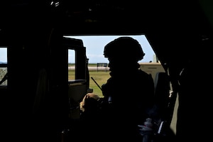 A man sits in a vehicle.