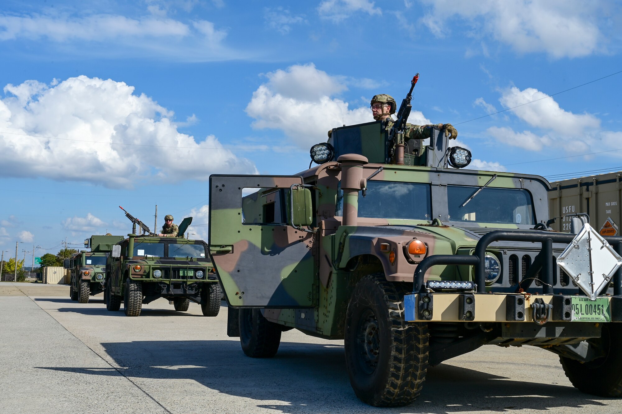 A group of vehicles drives by.