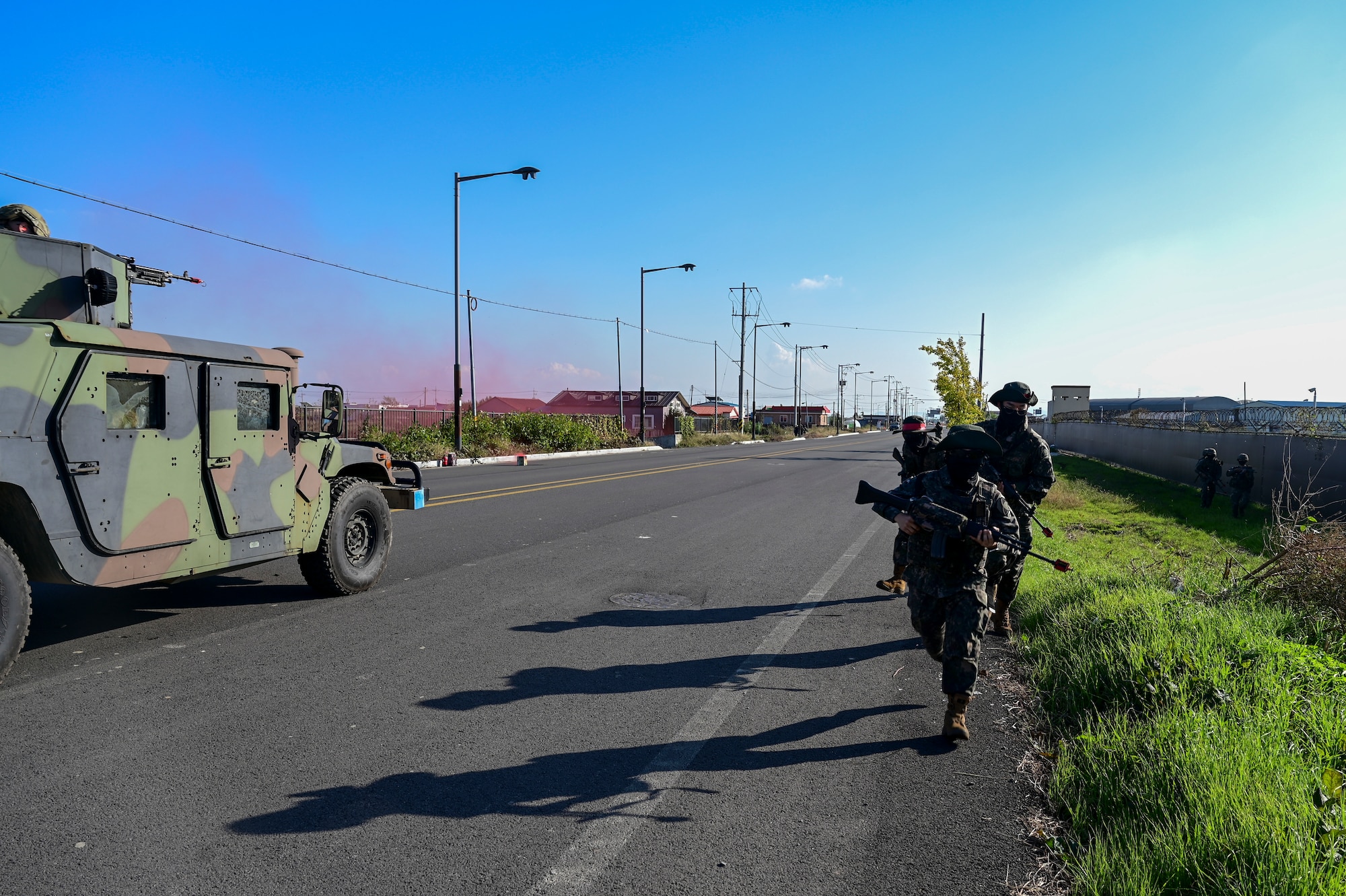 People run by a vehicle.