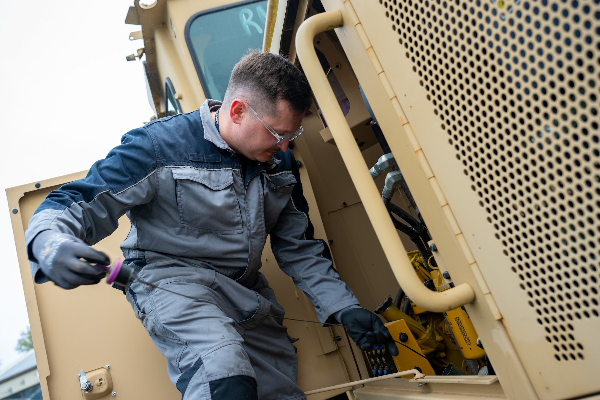 Charles Brett, a main workshop mechanic assigned to the 420th Air Base Squadron Logistics Readiness Flight Vehicle Management shop, inspects a vehicle at RAF Fairford, England, Oct. 16, 2025. The 420th LGRV Vehicle Management shop maintains and repairs vehicles that support aircraft, airfield operations, and base logistics. (U.S. Air Force photo by Airman 1st Class Adam Enbal)