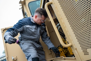 Charles Brett, a main workshop mechanic assigned to the 420th Air Base Squadron Logistics Readiness Flight Vehicle Management shop, inspects a vehicle at RAF Fairford, England, Oct. 16, 2025. The 420th LGRV Vehicle Management shop maintains and repairs vehicles that support aircraft, airfield operations, and base logistics. (U.S. Air Force photo by Airman 1st Class Adam Enbal)