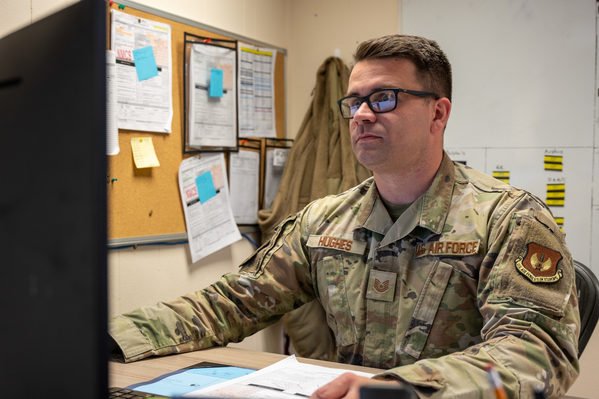 Tech. Sgt. Christopher Hughes, 420th LGRV Fleet Management and Analysis noncommissioned officer in charge, works at his desk at RAF Fairford, England, Oct. 16, 2025. The 420th LGRV Vehicle Management shop maintains and repairs vehicles that support aircraft, airfield operations, and base logistics. (U.S. Air Force photo by Airman 1st Class Adam Enbal)