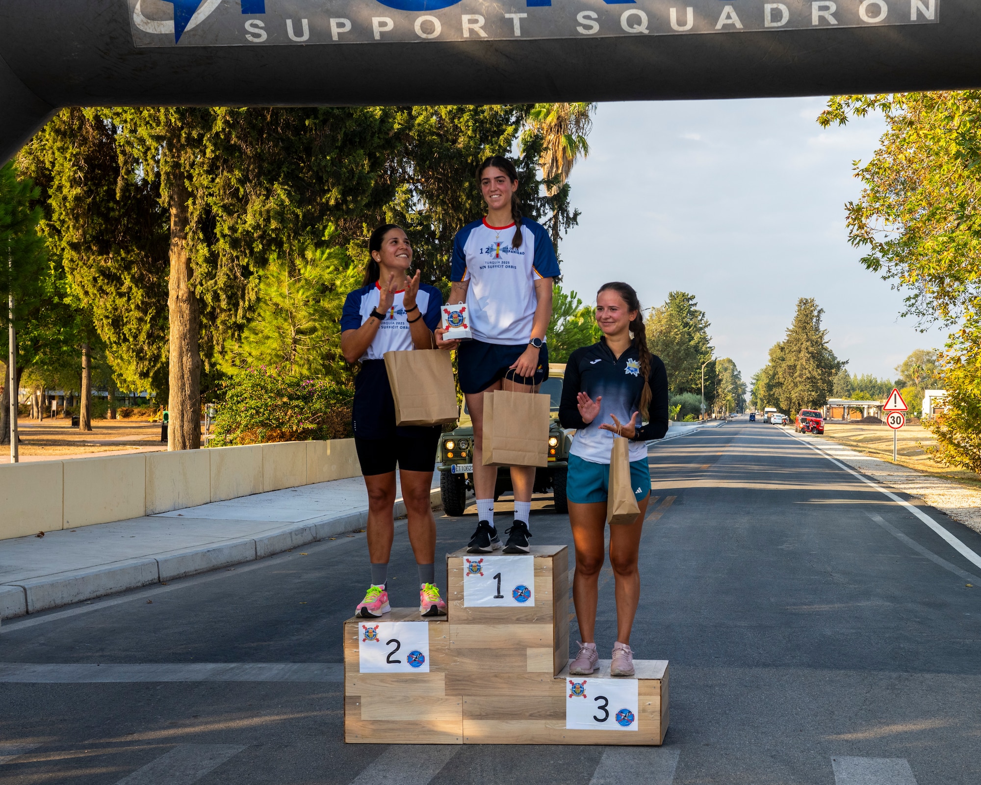 The top female finishers receive recognition following a Spanish 5K