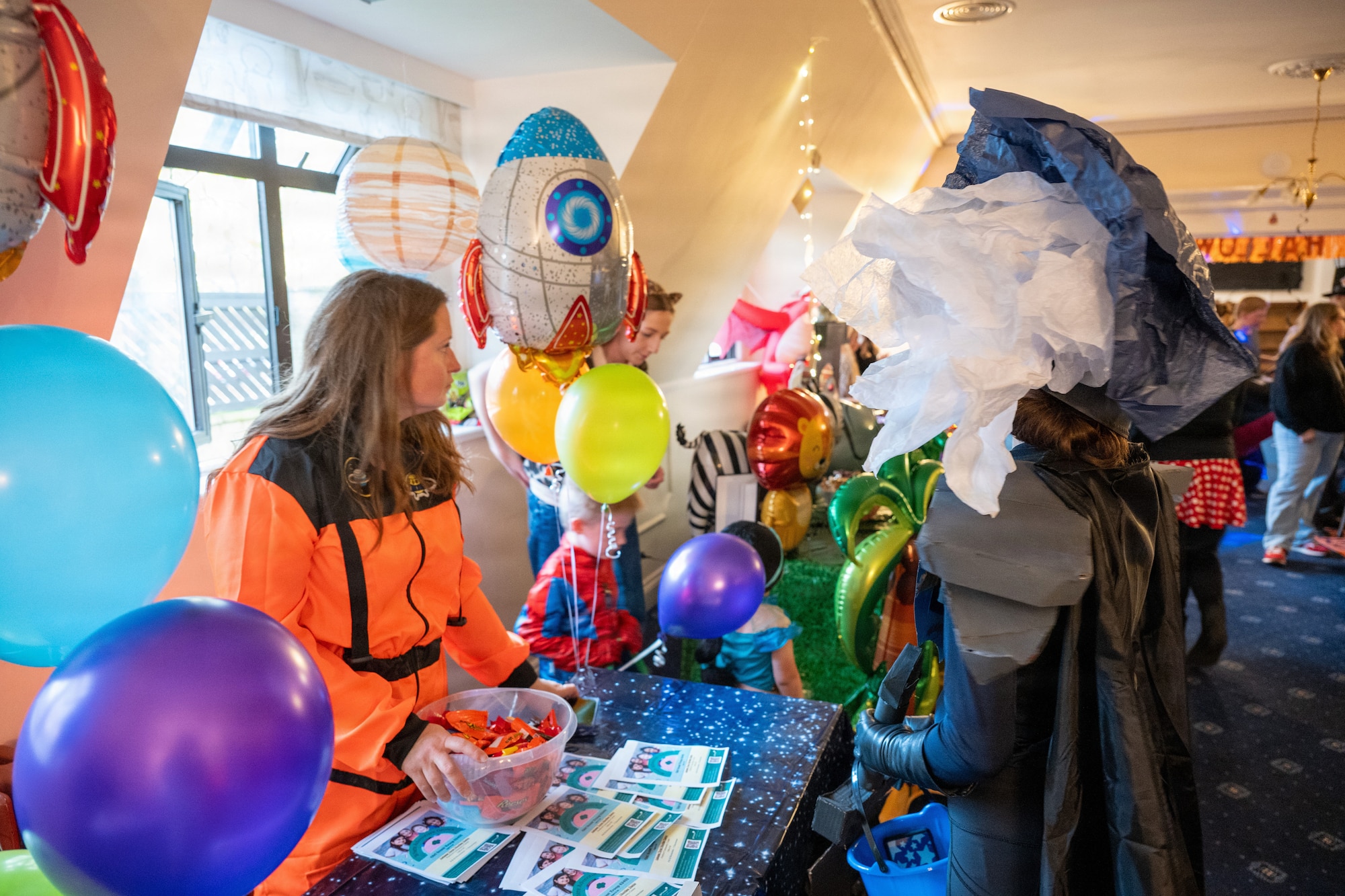 Participants in creative costumes visit themed booths