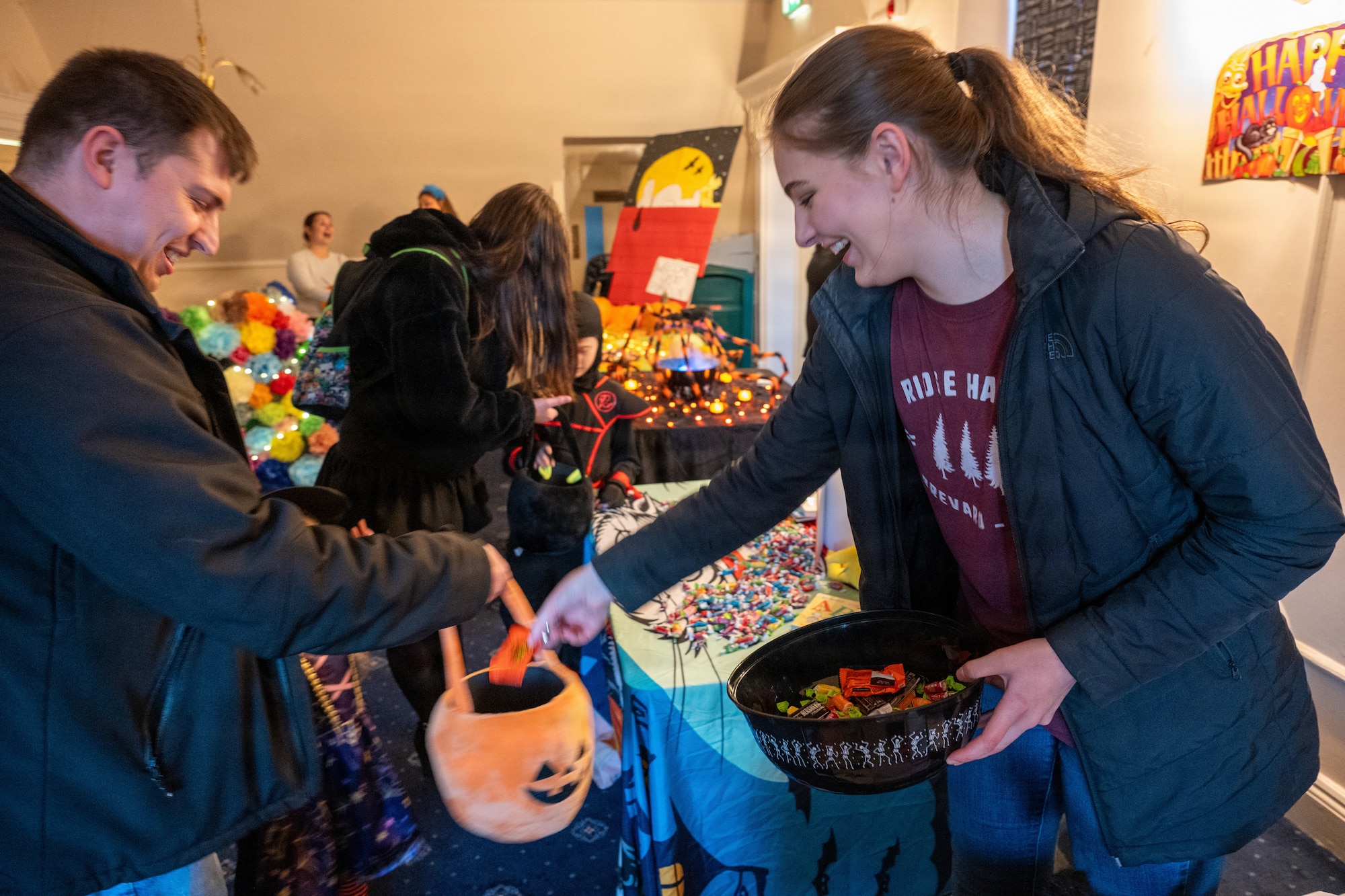 A volunteer hands out candy