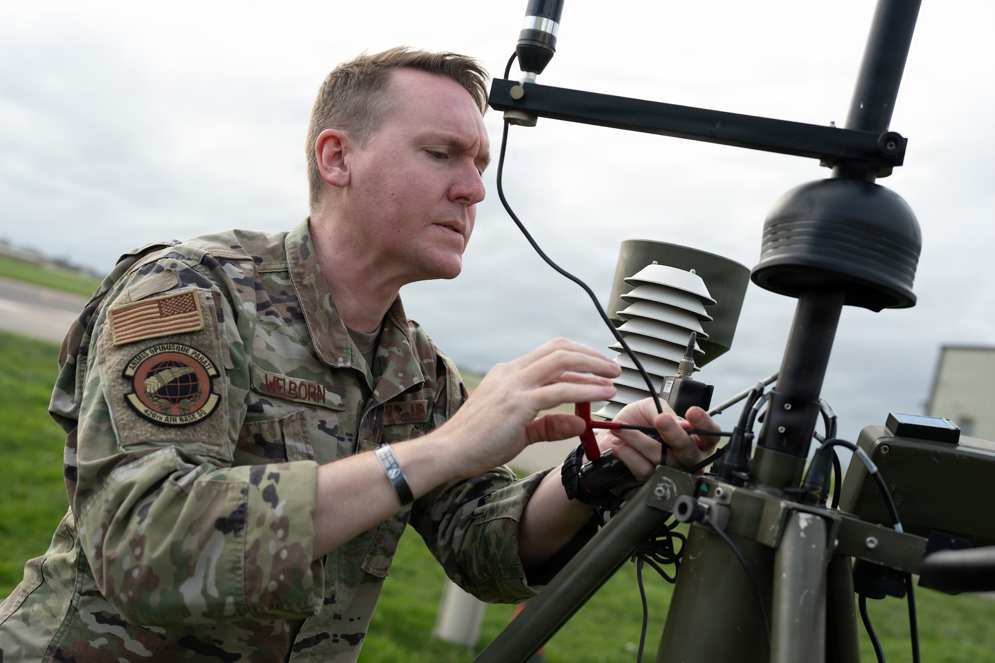 U.S. Air Force Master Sgt. Robert Welborn, 420th Air Base Squadron Flight Chief of Weather Operations, adjusts sensors