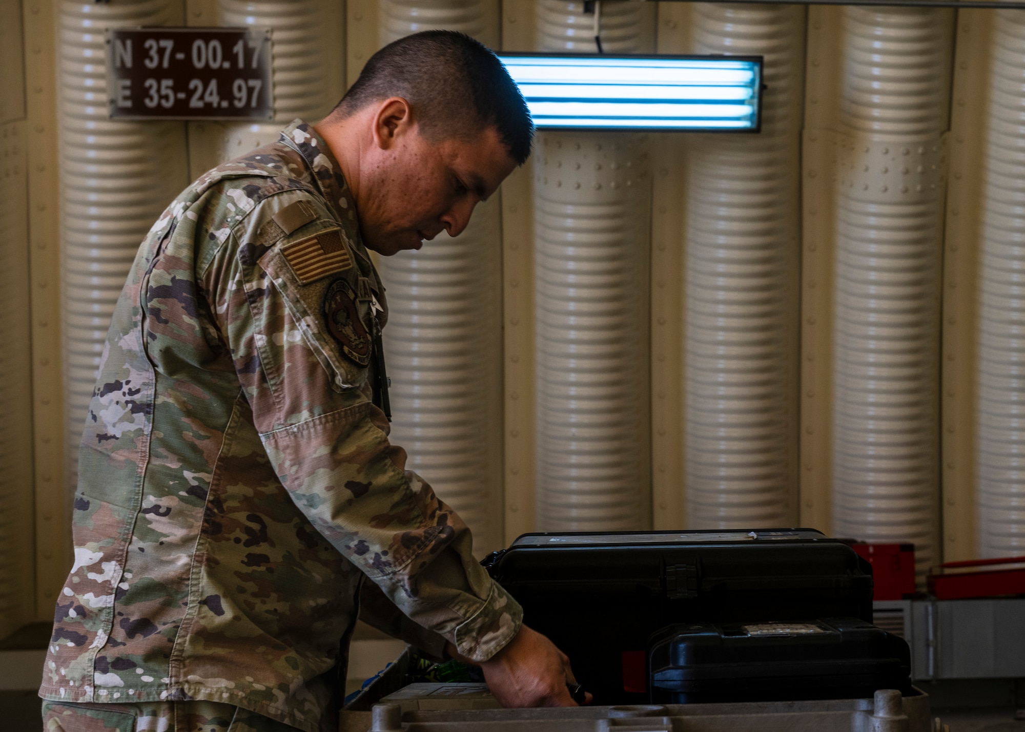 A service member  conducts equipment checks