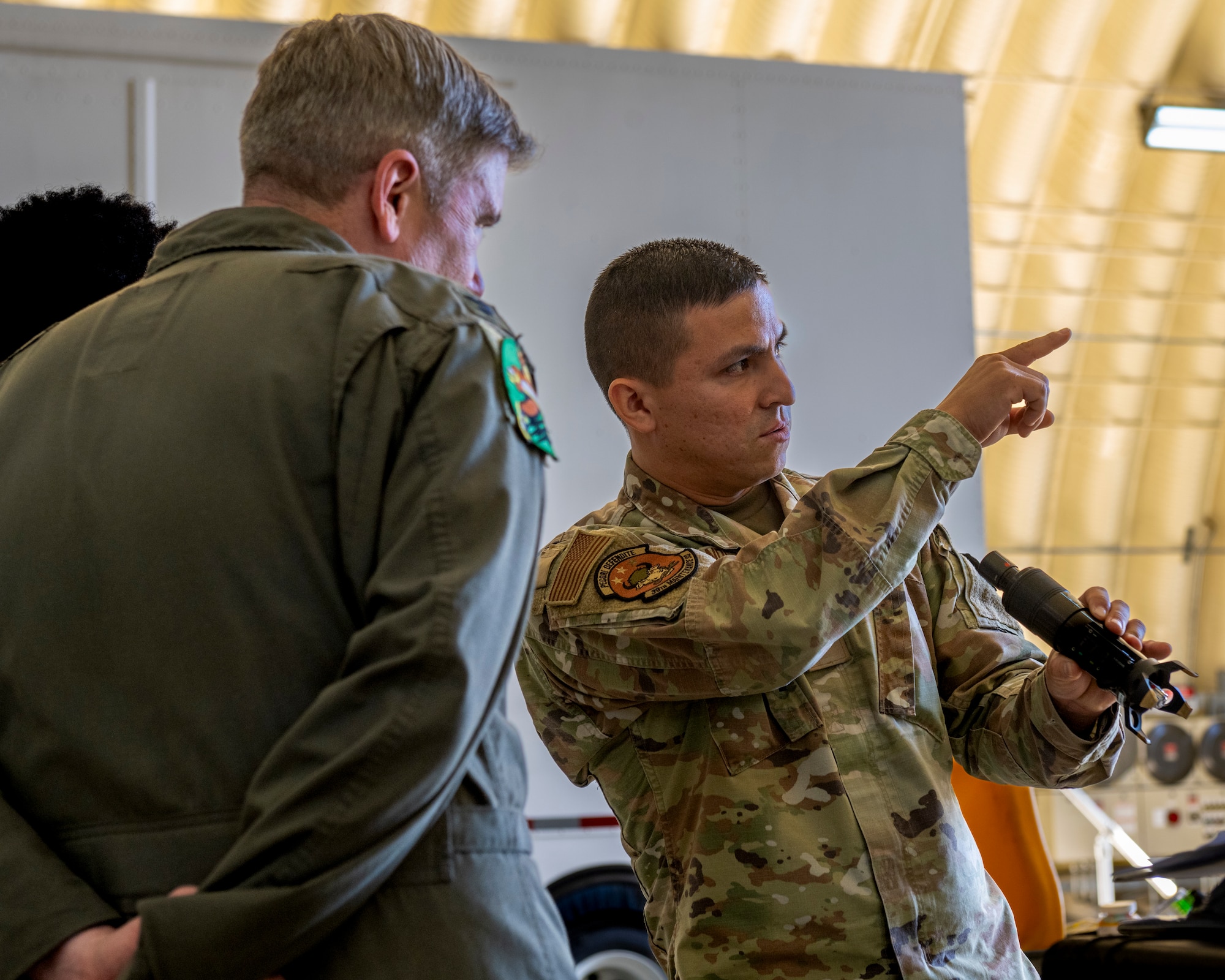 A service member explains maintenance procedures