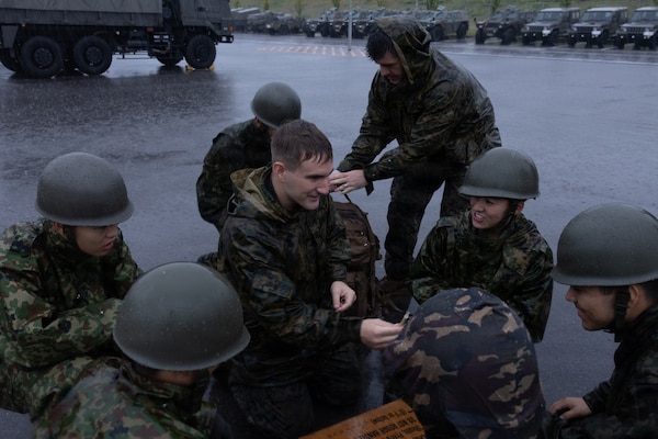 U.S. Navy Sailors and Japanese Ground Self-Defense Force members participate in a medical skills relay competition during exercise 07JX on Ishigaki, Okinawa, Japan, Oct 25, 2025. 07JX is a bilateral exercise that aims to enhance bilateral Japan-U.S. capabilities for humanitarian assistance and disaster relief operations in the Southwest islands. (U.S. Marine Corps photo by Lance Cpl. Marcus Henson)