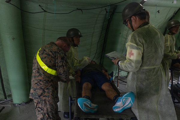 U.S. Navy Sailors and Japan Ground Self-Defense Force Members conduct treatment of a simulated casualty during exercise 07JX on Ishigaki, Okinawa, Japan, Oct. 25, 2025. 07JX is a bilateral exercise that aims to enhance bilateral Japan-U.S. capabilities for humanitarian assistance and disaster relief operations in the Southwest islands. (U.S. Marine Corps photo by Lance Cpl. Marcus Henson)