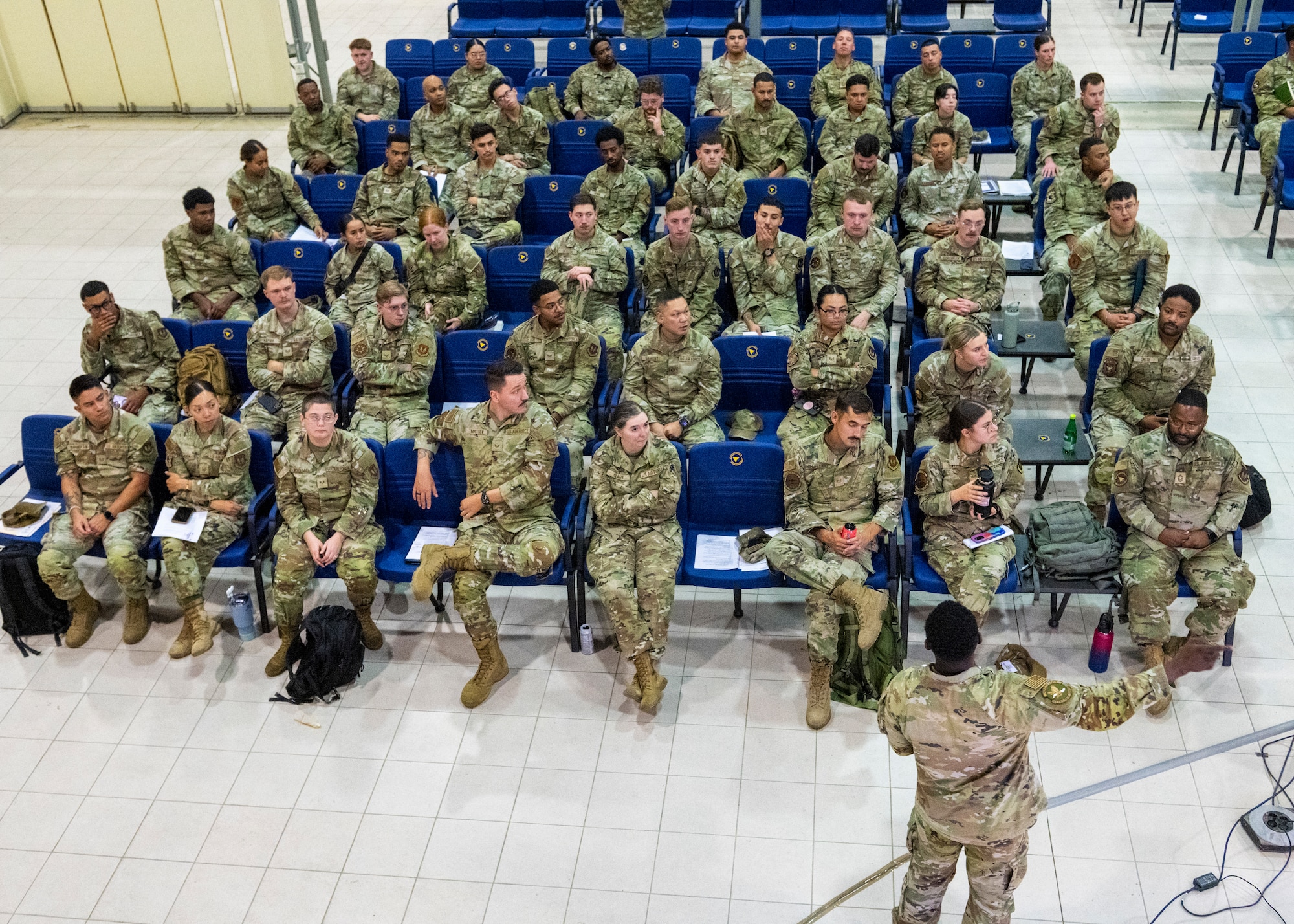 Service members sit for a briefing